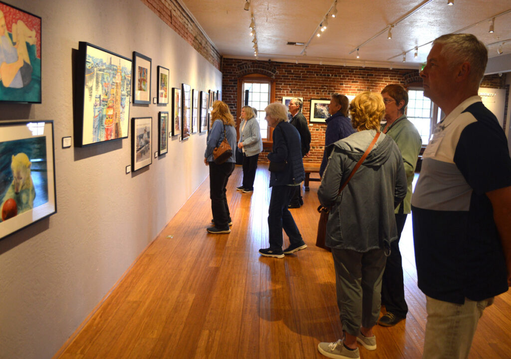 People looking at paintings.